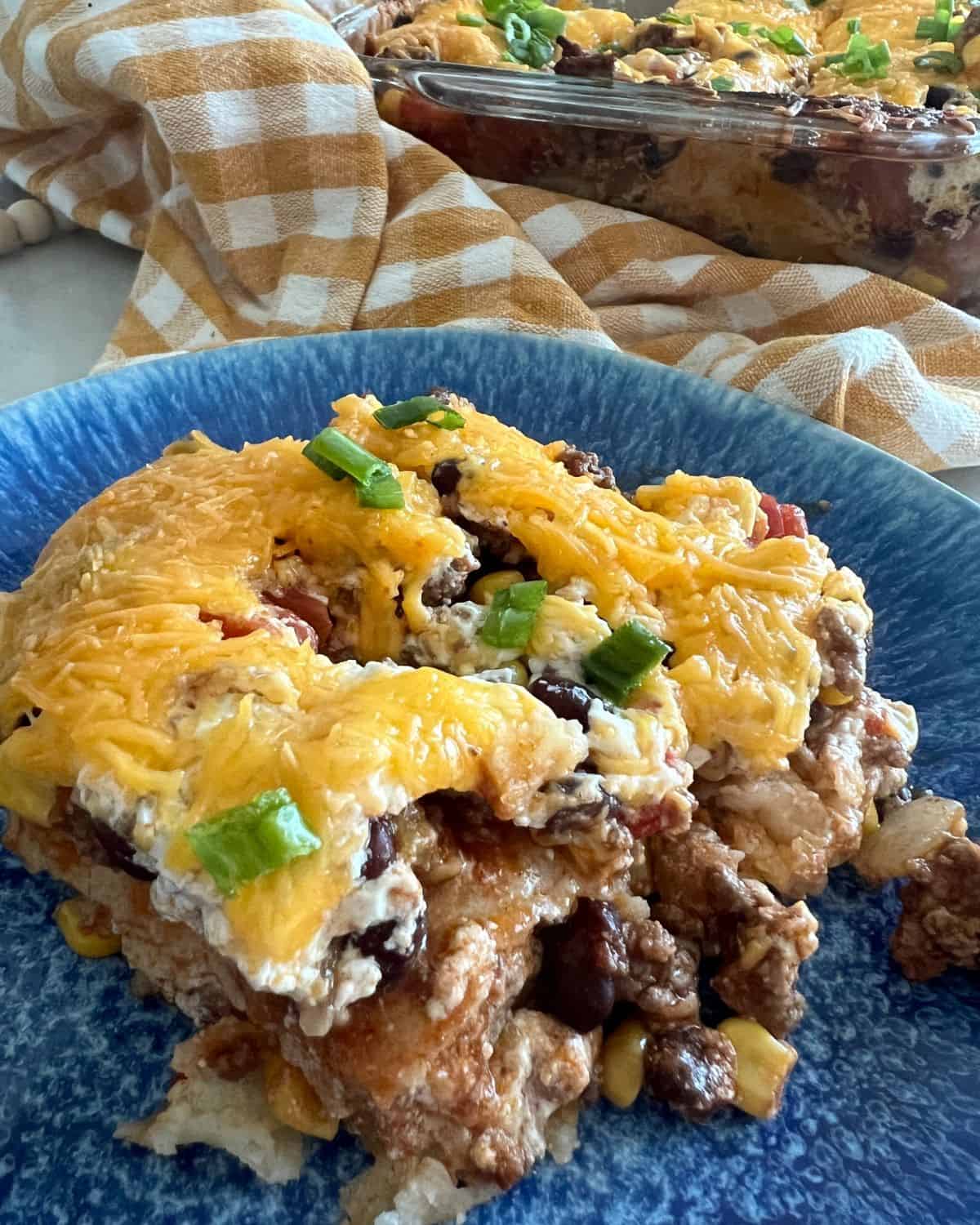 Mexican casserole on a blue plate. 