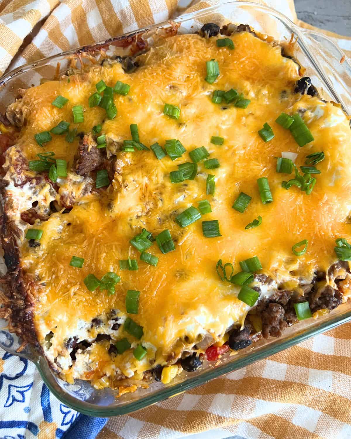 Finished Mexican casserole topped with green onions. 