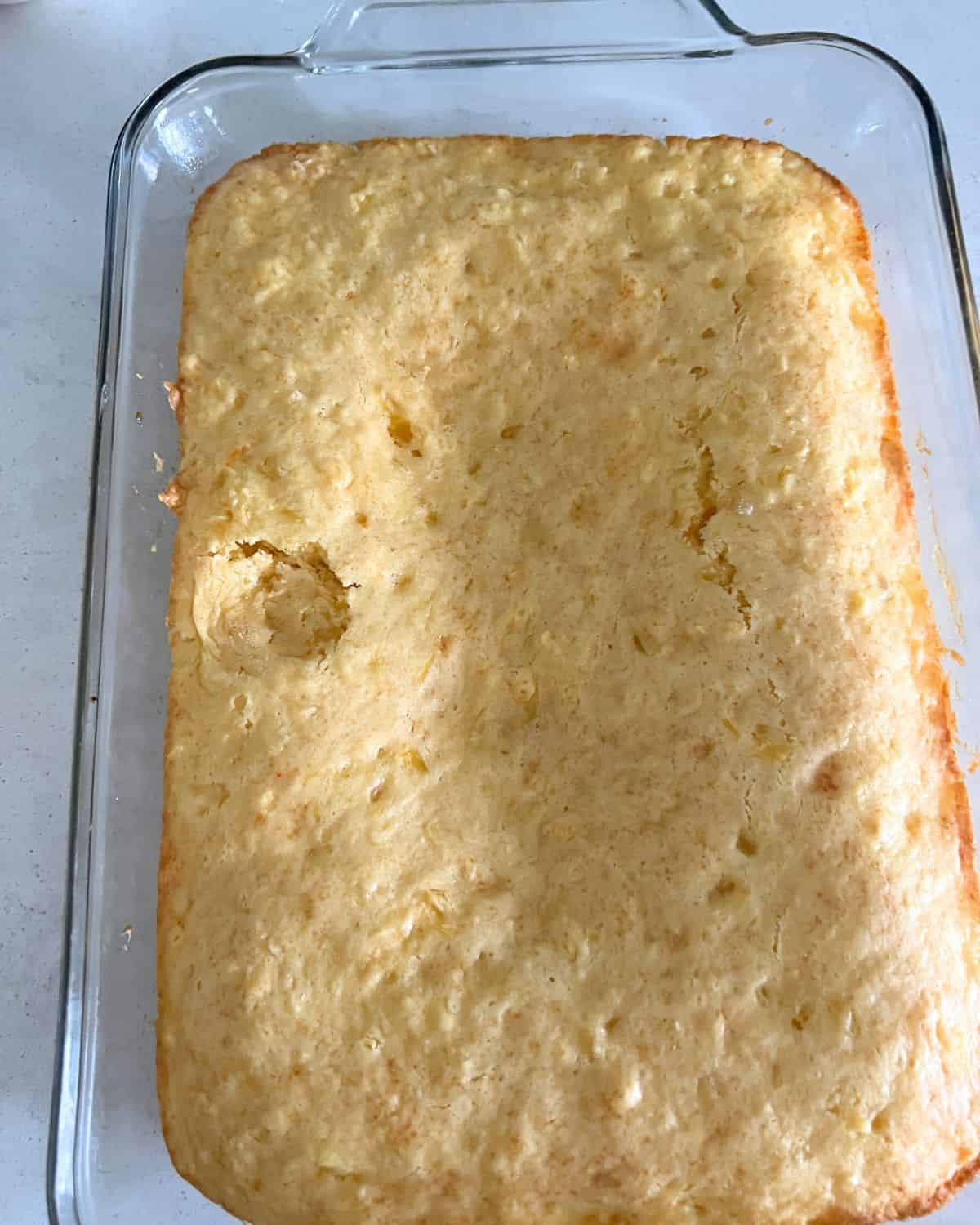 Baked pineapple cake mix in a pan.