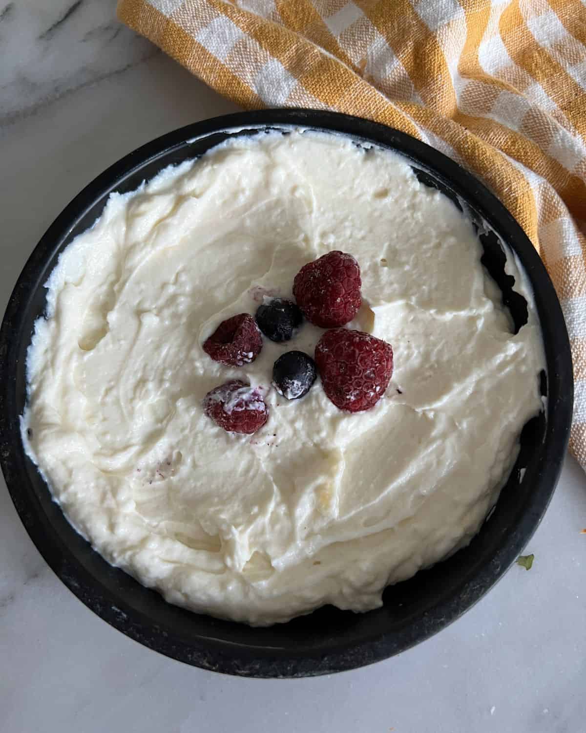 2 ingredient cheesecakes topped with fresh berries. 