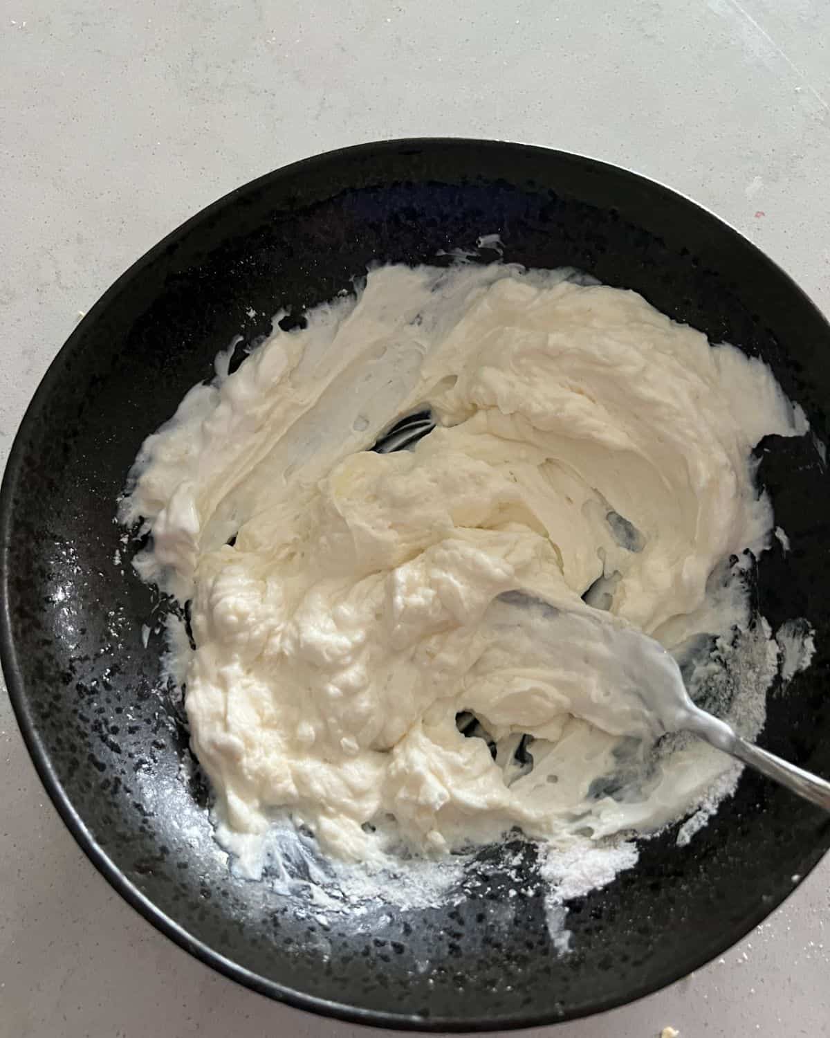 Cheesecake and yogurt mixed in a bowl. 