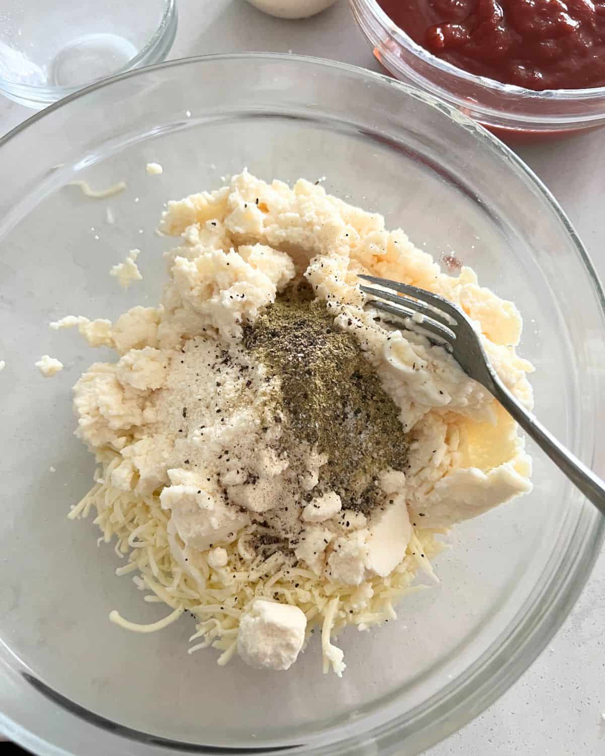 Cheese filling ingredients mixed together in a bowl. 