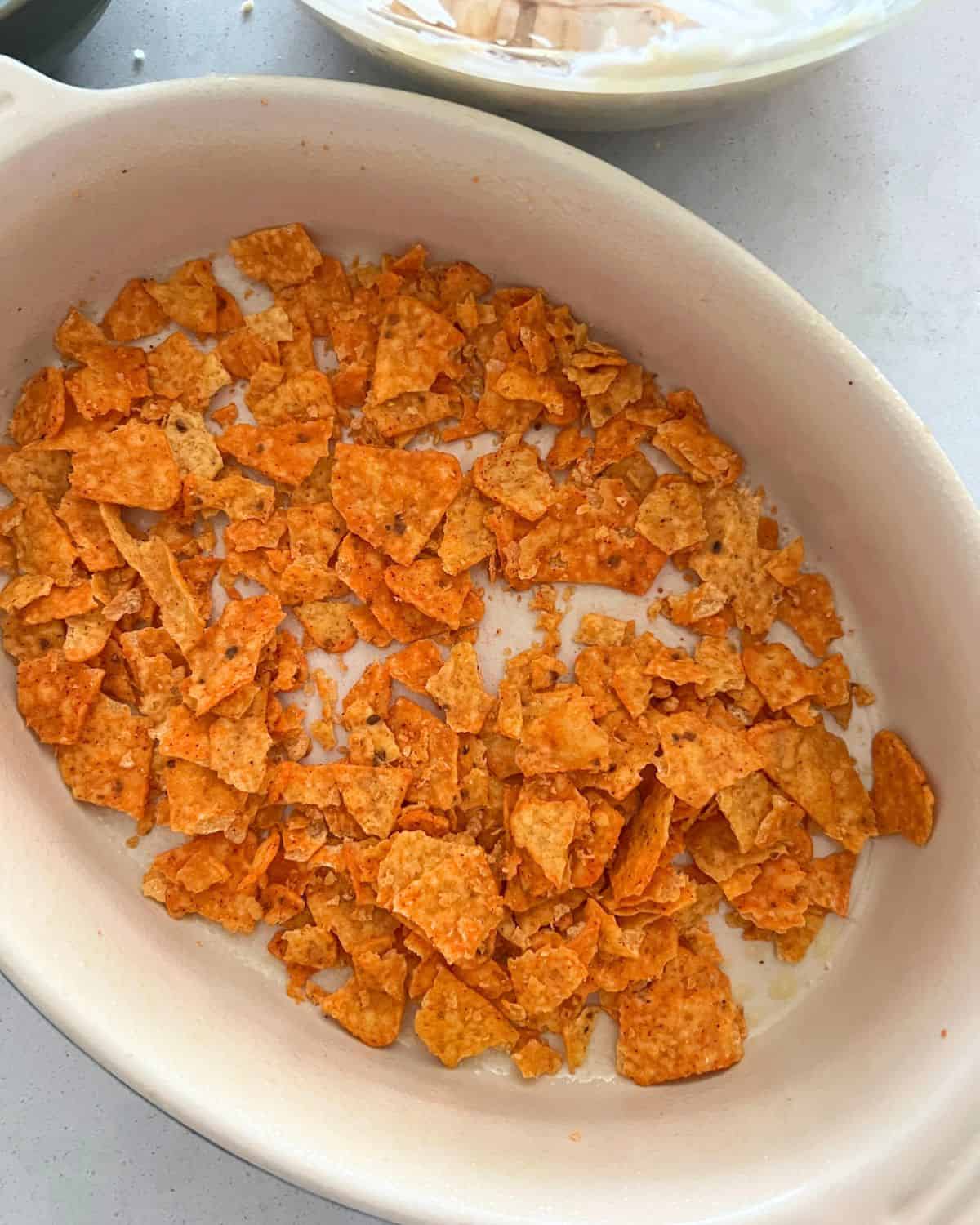 Crushed Doritos on the bottom of a casserole dish. 