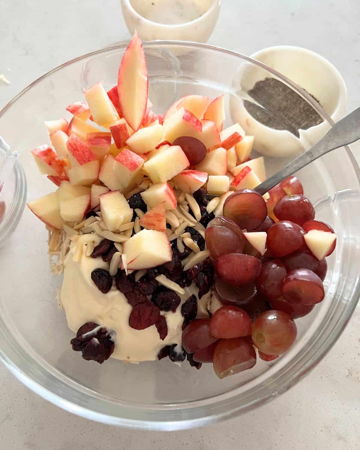 All the ingredients for chicken salad in a bowl. 