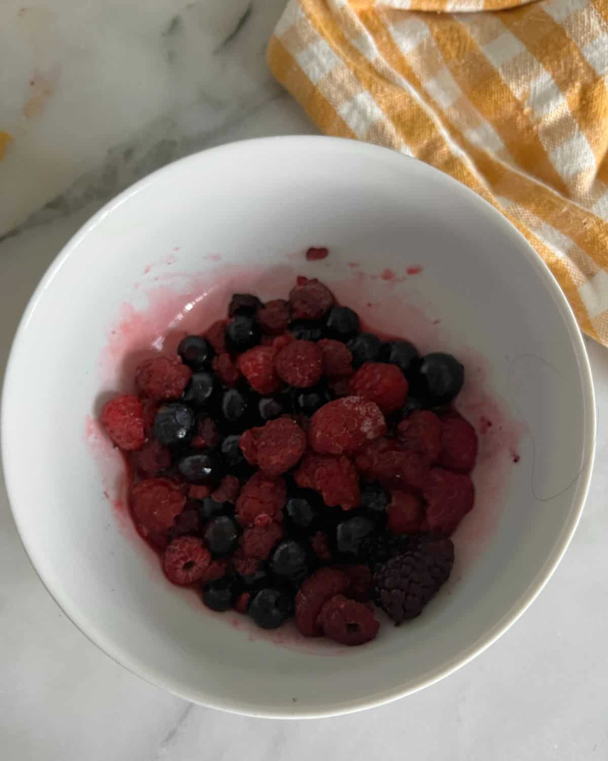 Defrosted berries in a bowl. 