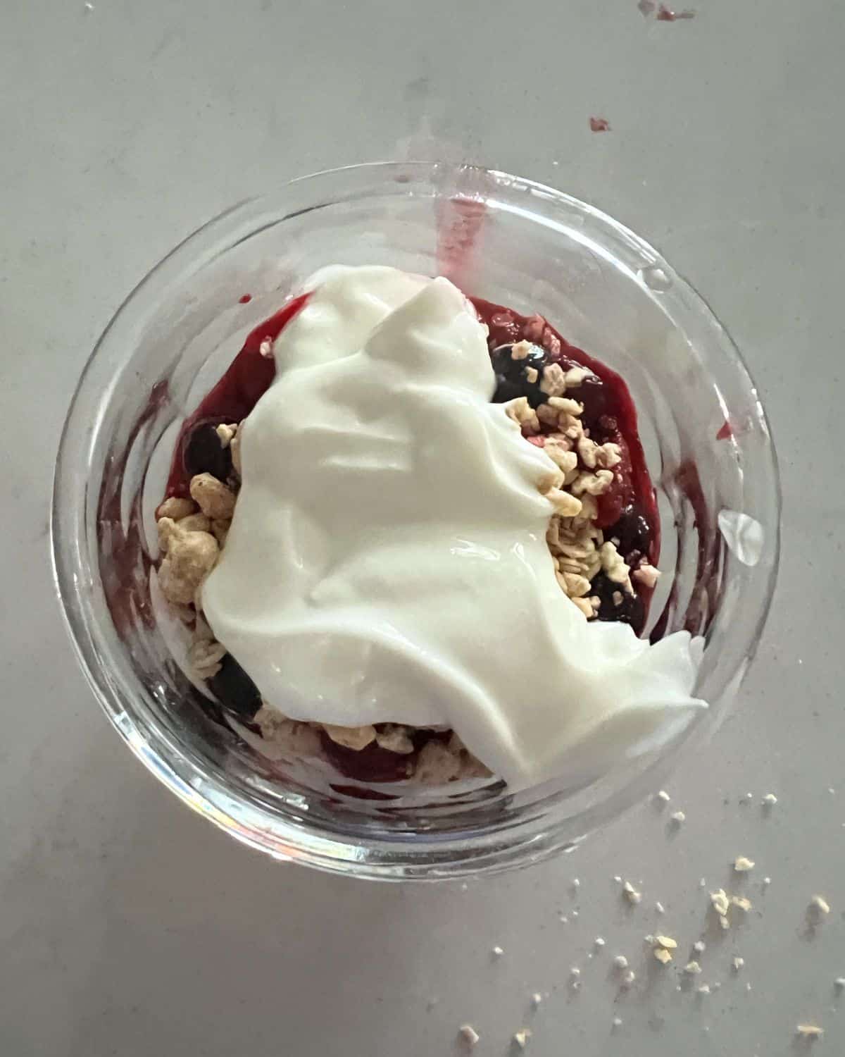 Layered fruit and yogurt parfait in a glass jar.