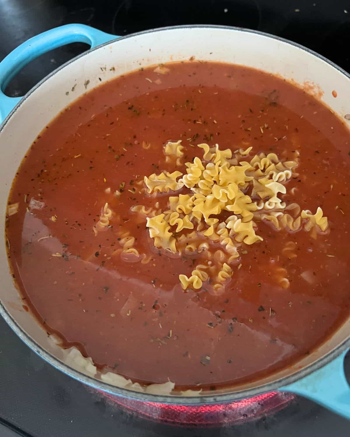 Uncooked noodles in a soup pot waiting to be simmered. 