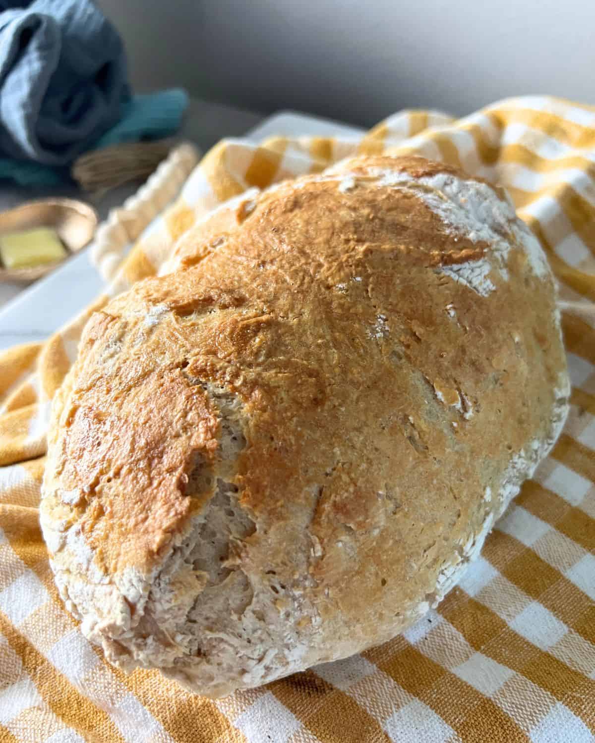 Finished no knead bread on a yellow napkin. 