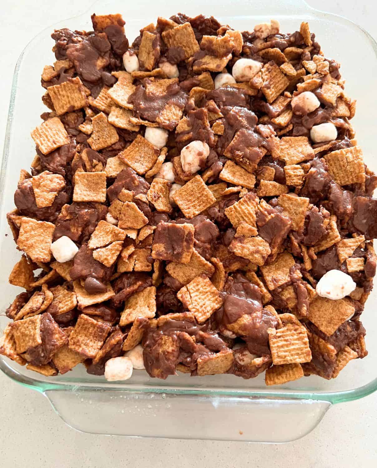 Golden graham and marshmallow mixture in a greased baking dish. 