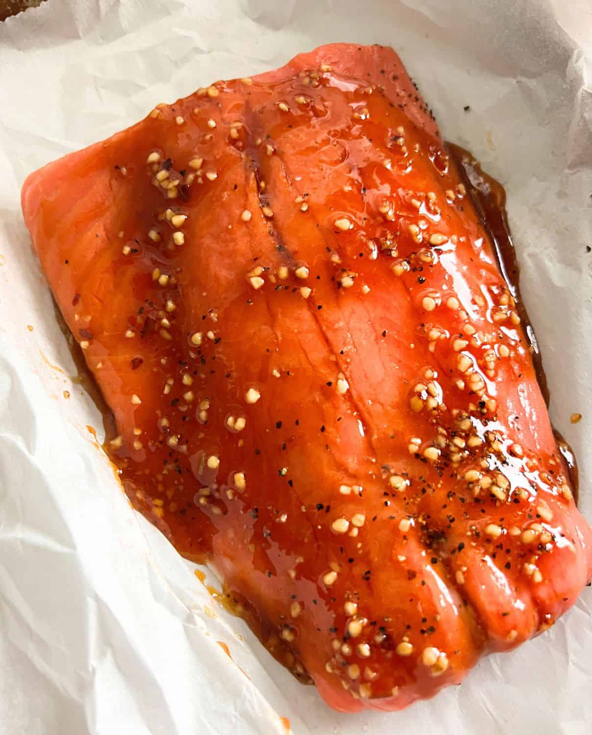 Firecracker sauce brushed on top of salmon. 