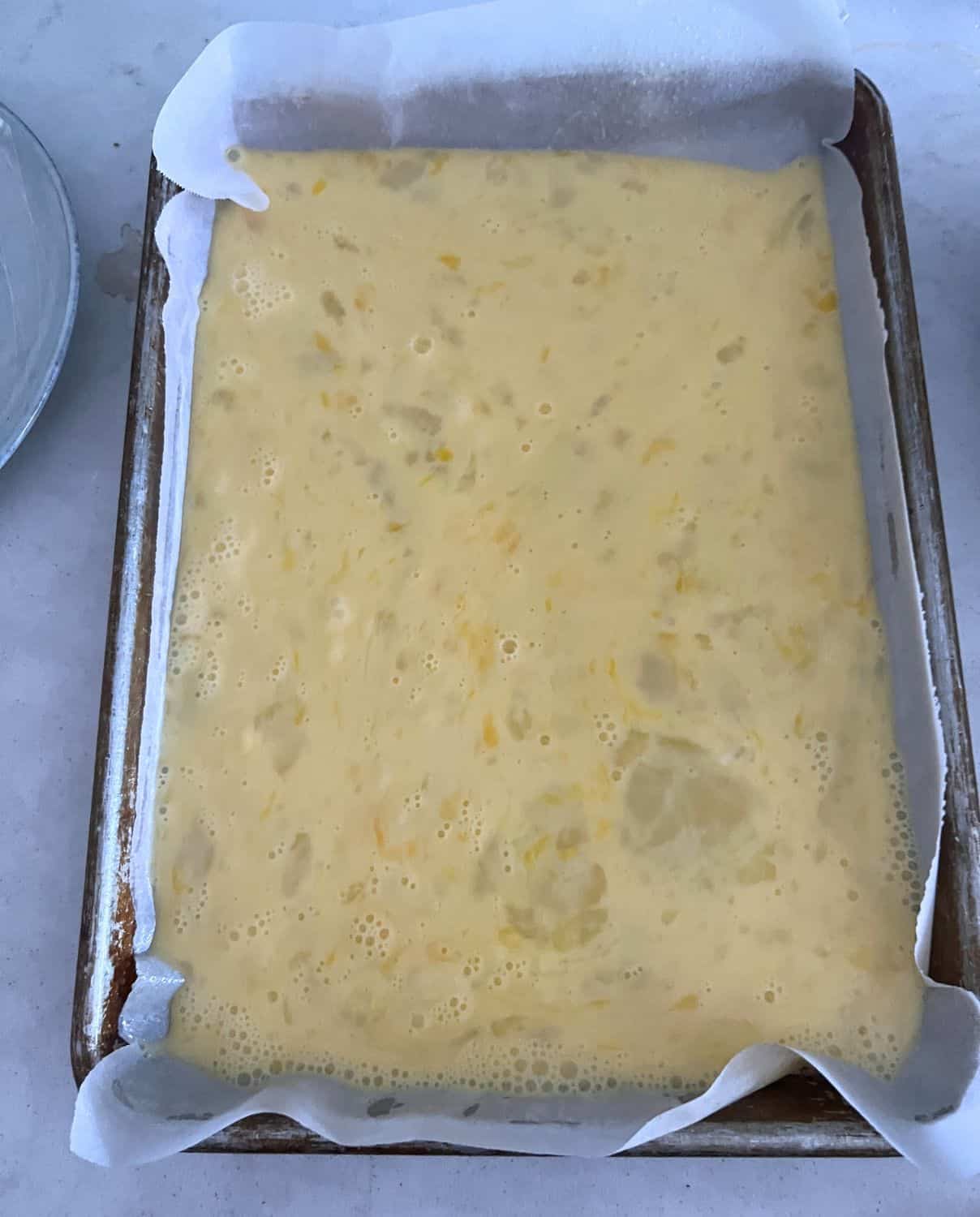 Whisked eggs and milk on a sheet pan. 