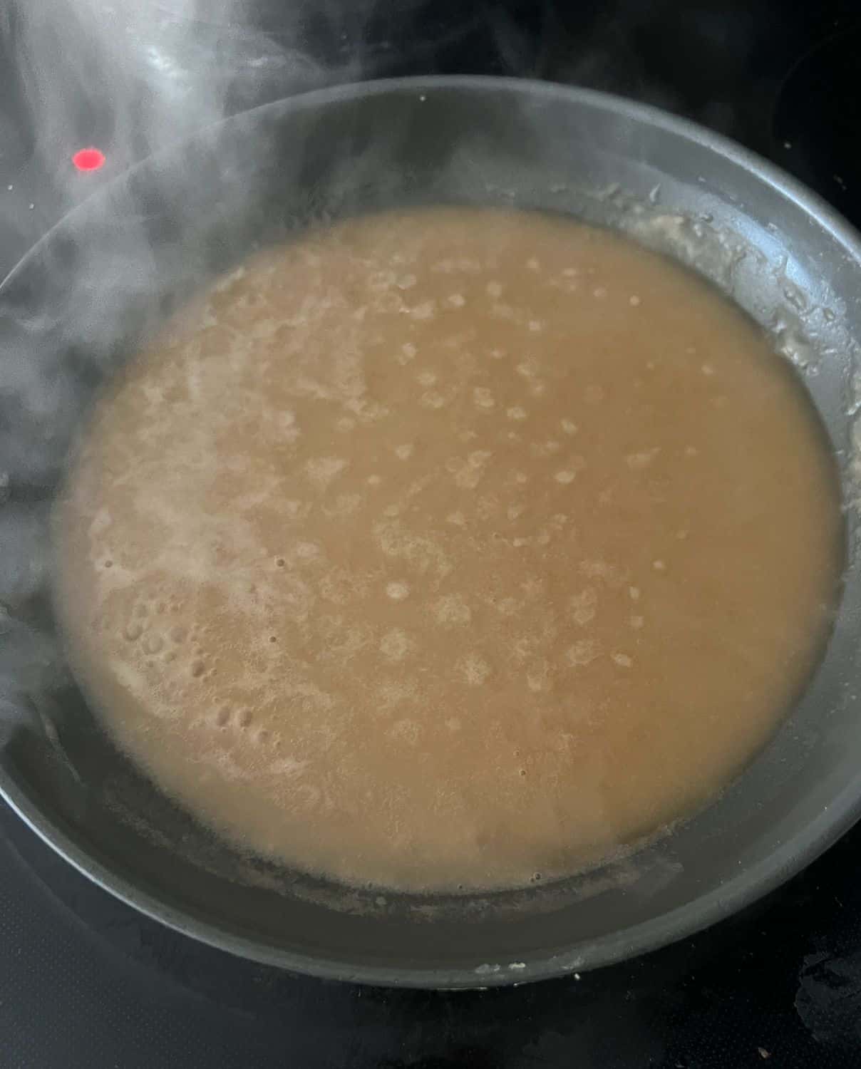 Beef broth simmering with butter and flour in a pan. 