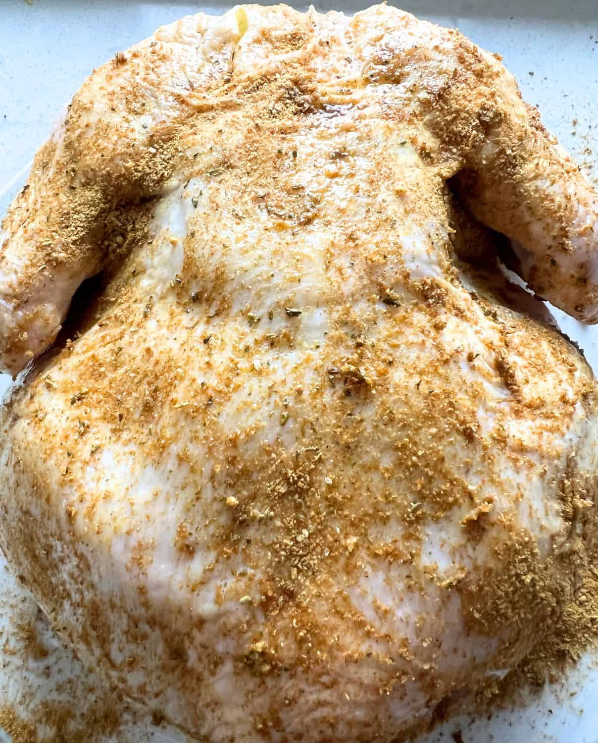 Seasoned whole chicken ready for air fryer. 