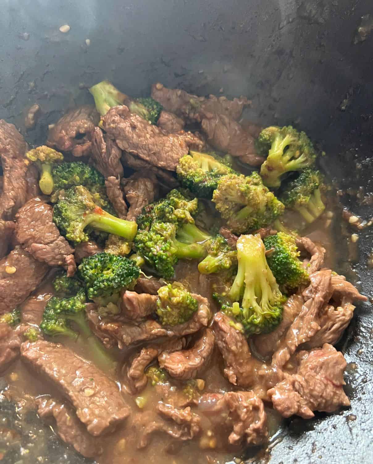 Beef mixed with broccoli in a pan. 