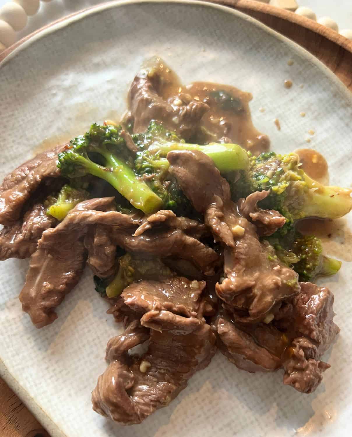 Beef and broccoli on a white plate. 