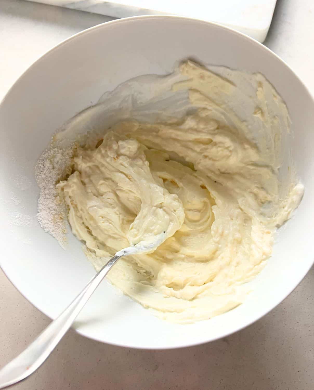 Greek Yogurt and dry pudding mix combined in a bowl. 