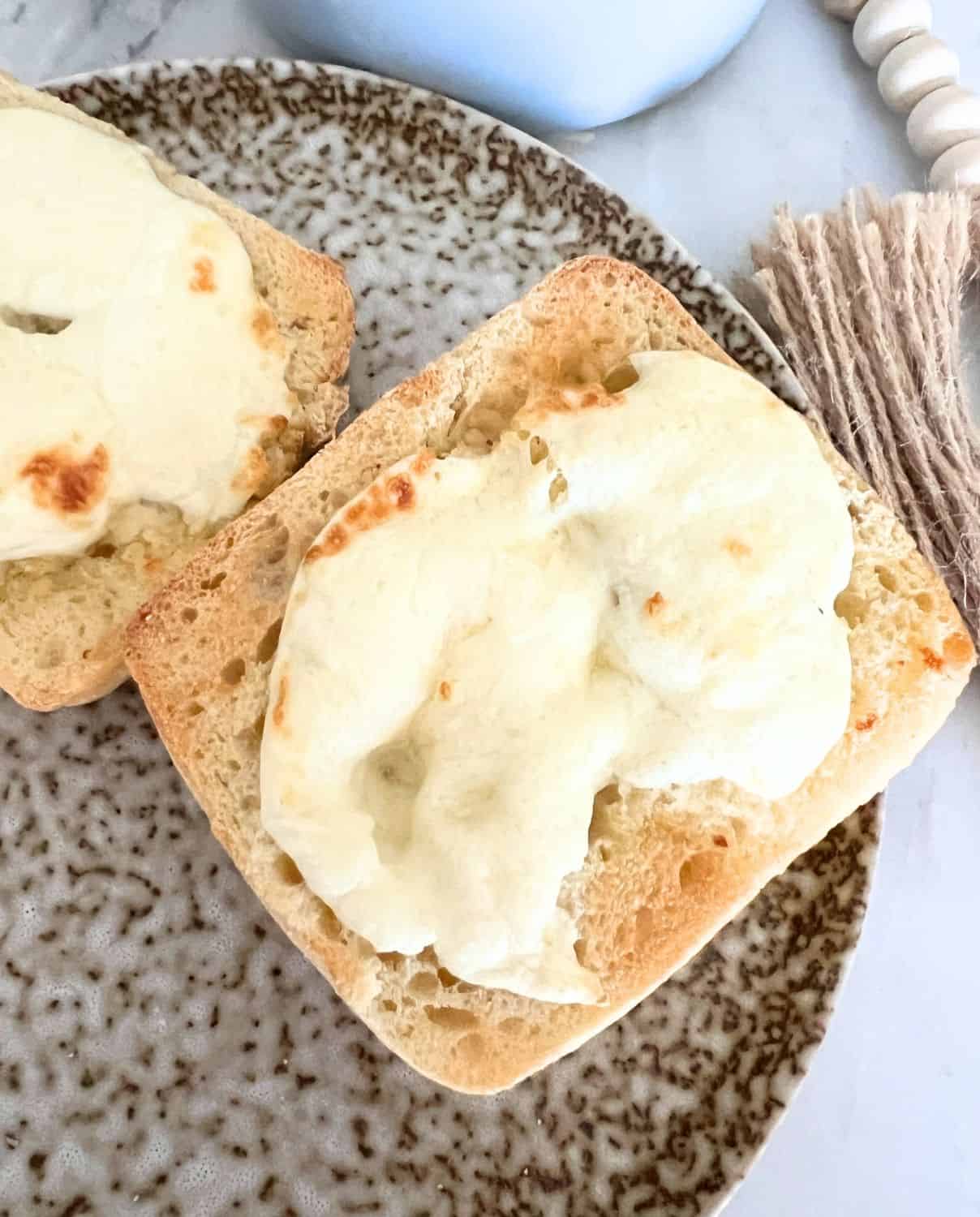 Cheesy Garlic Ciabatta bread on a brown plate. 