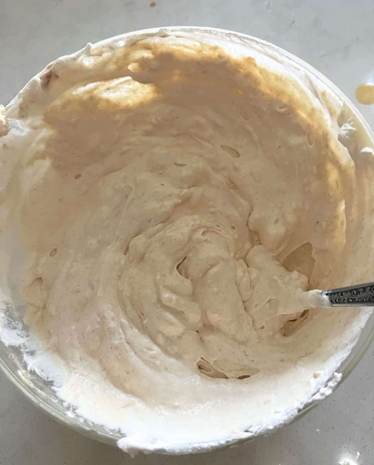 Cream cheese, Cool Whip, and Peanut butter mixed together in a bowl.