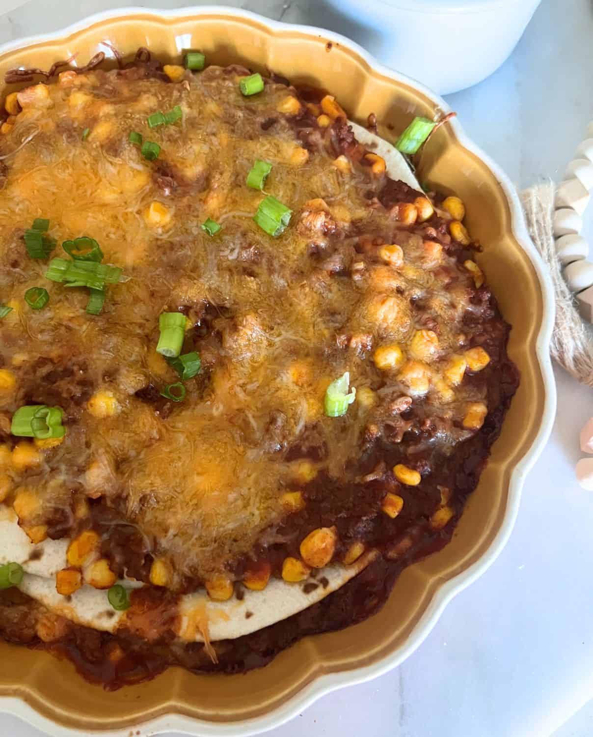 Finished Taco pie in a brown casserole pie dish. 