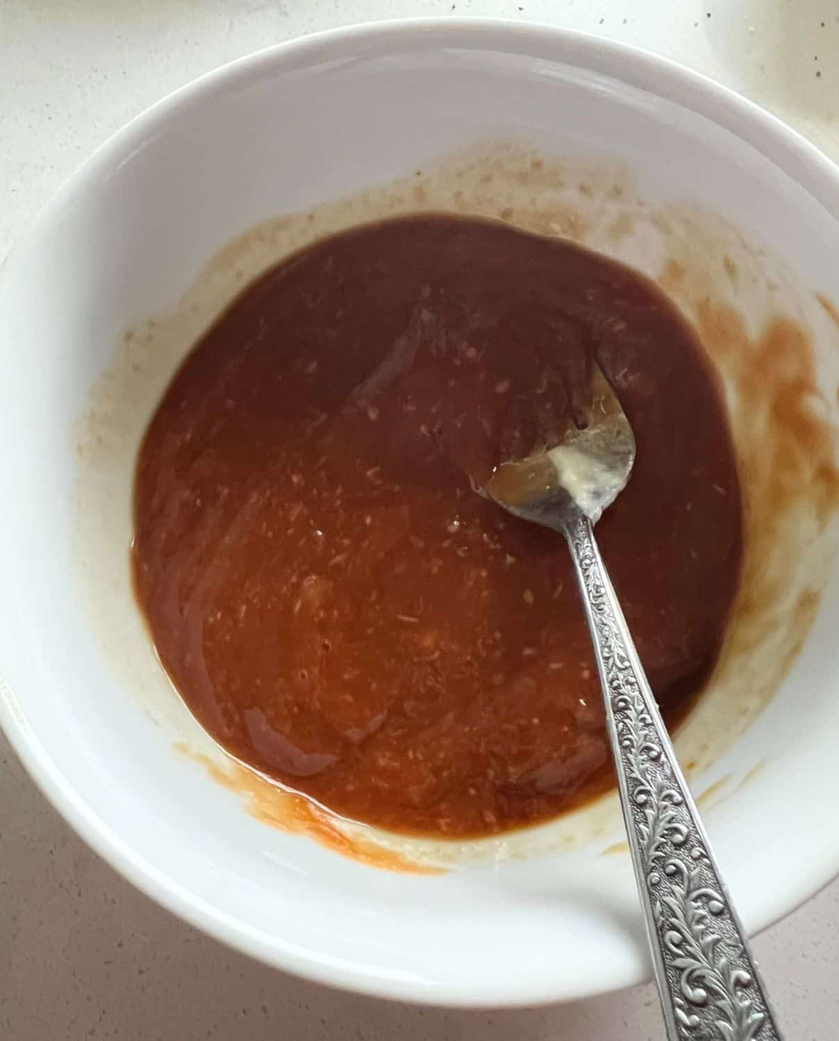 Ketchup, Sauce, and Horseradish mixed together in a bowl. 