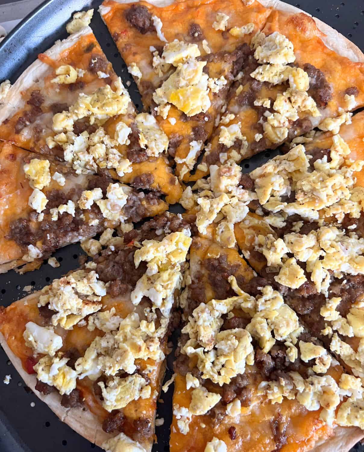 Casey's copycat breakfast pizza with eggs, nacho cheese sauce, and sausage. 