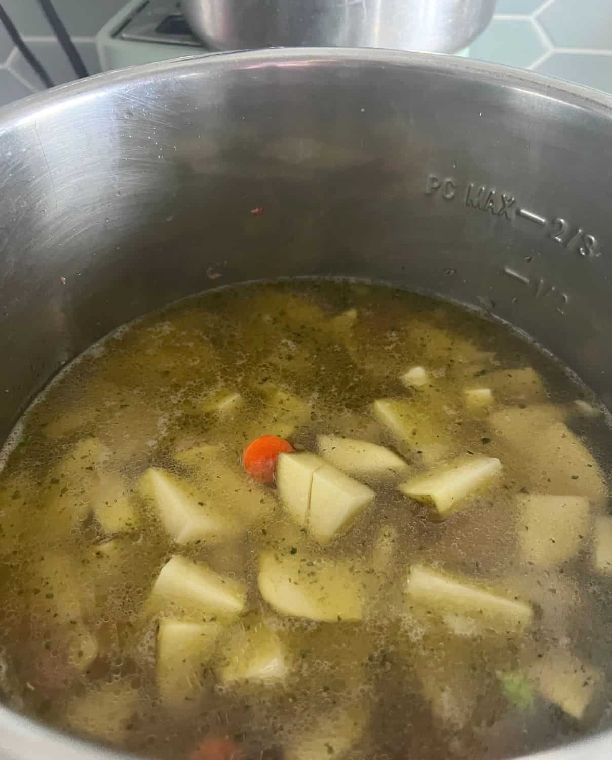 Potatoes and chicken stock adding into the soup. 