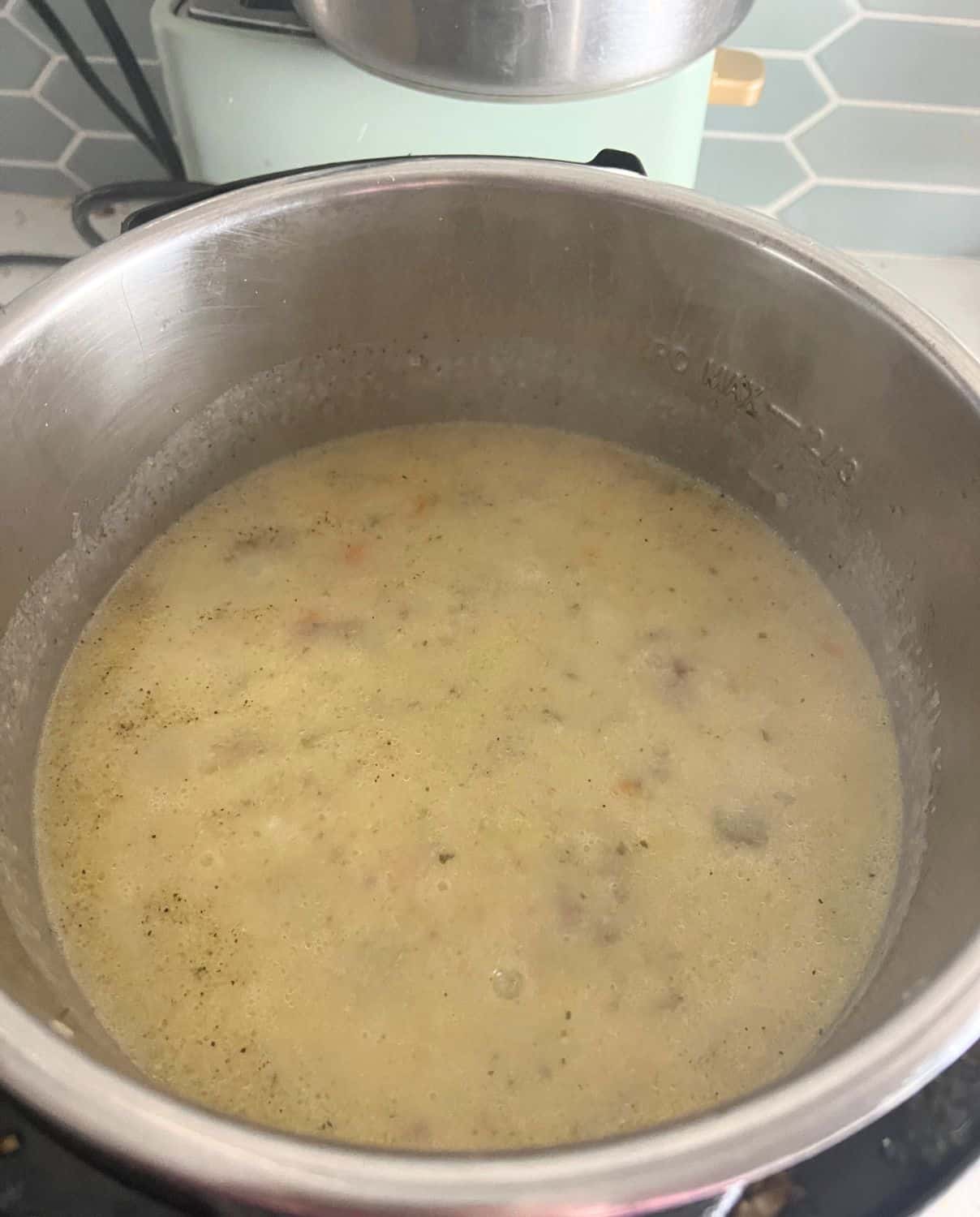Milk and slurry in cheeseburger soup in the Instant Pot.
