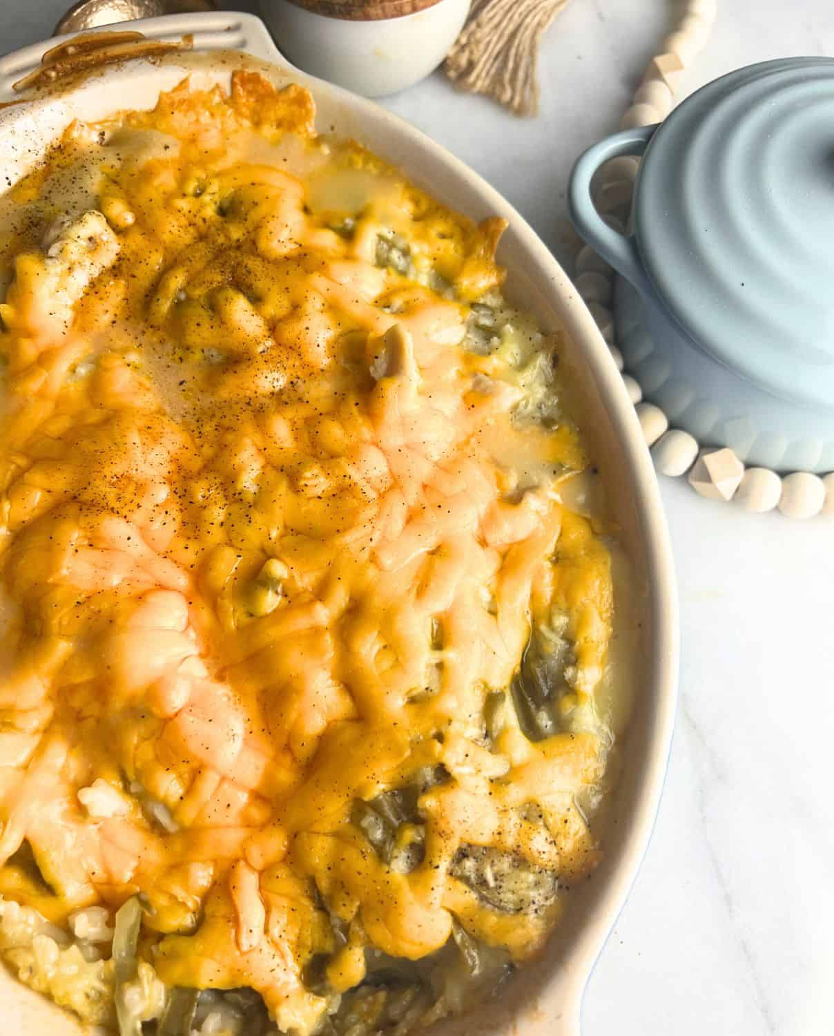 Finished chicken green bean casserole topped with melted cheese.