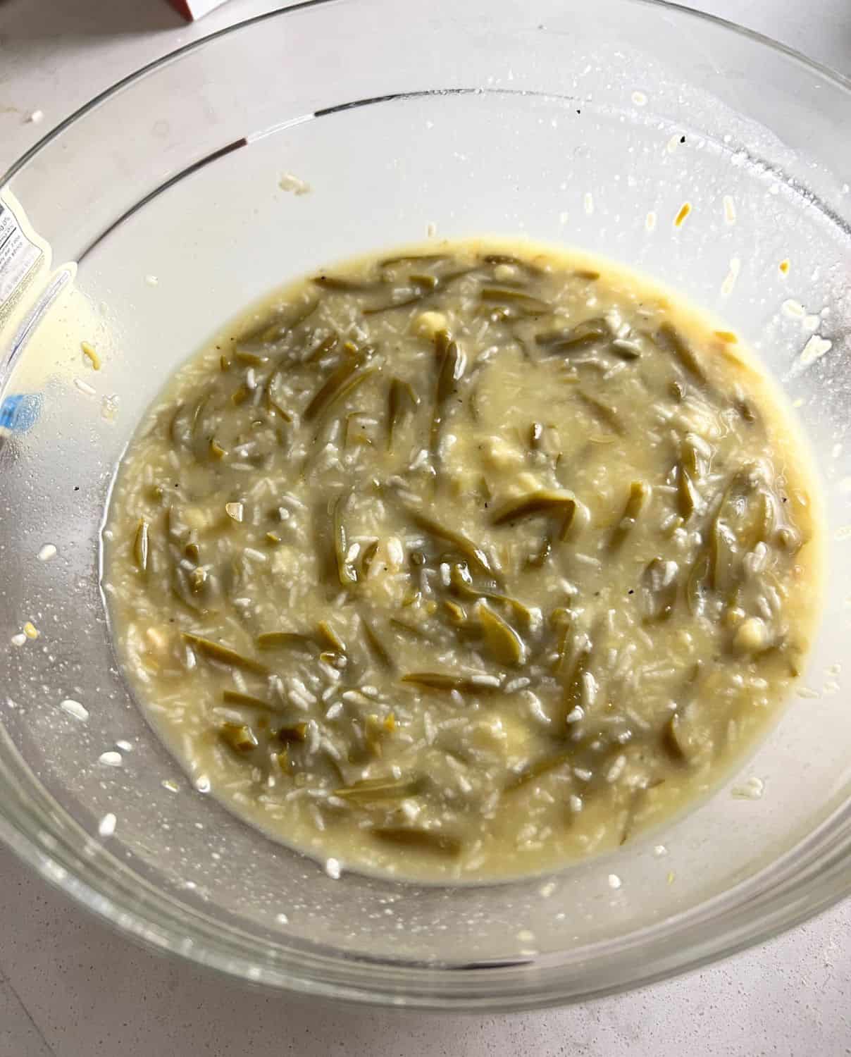 Chicken Green Bean casserole ingredients mixed together in a bowl.