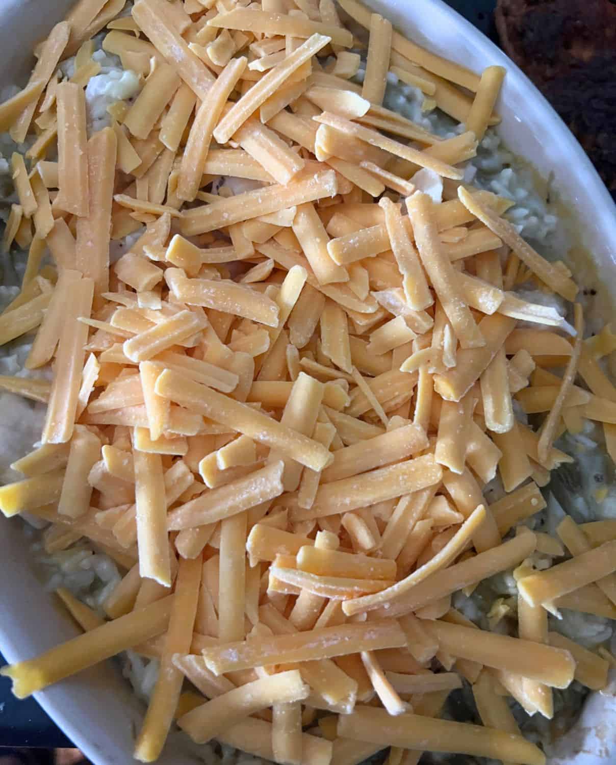 Casserole covered with cheddar cheese.