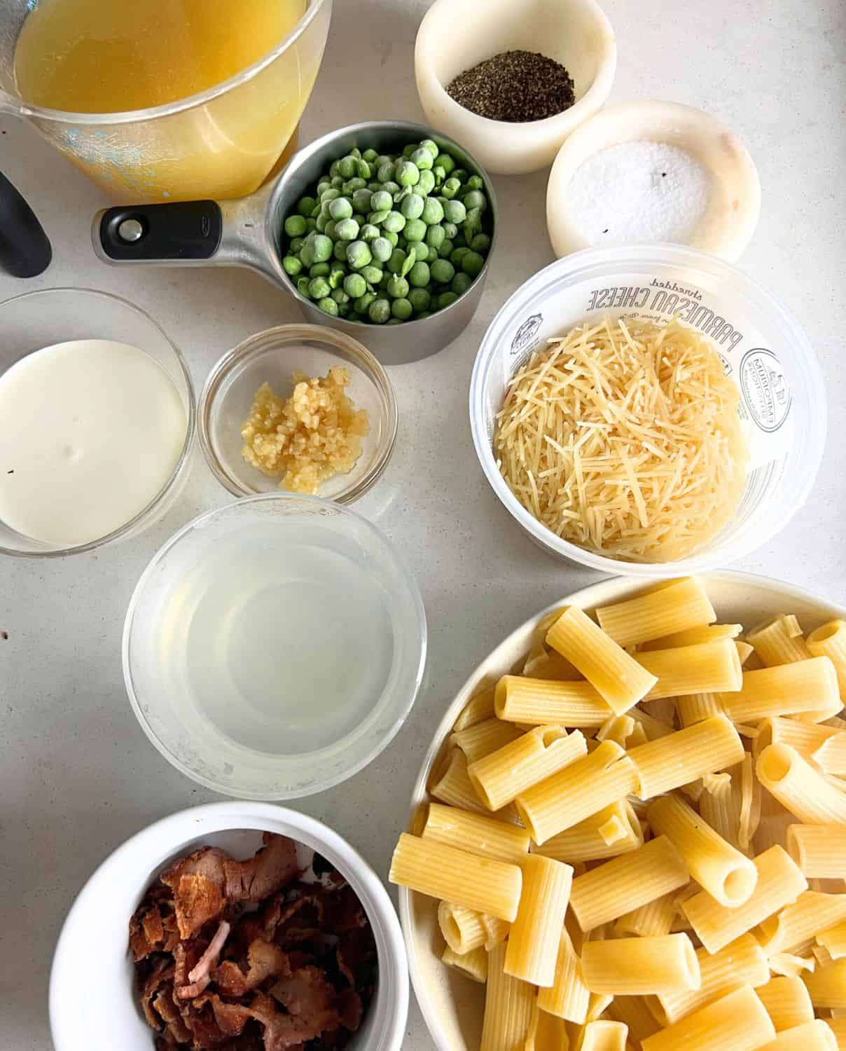 Ingredients needed for creamy alfredo with bacon and peas. 