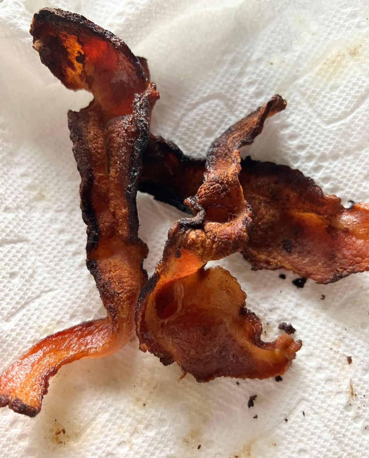 Crispy cooked bacon on a paper towel. 