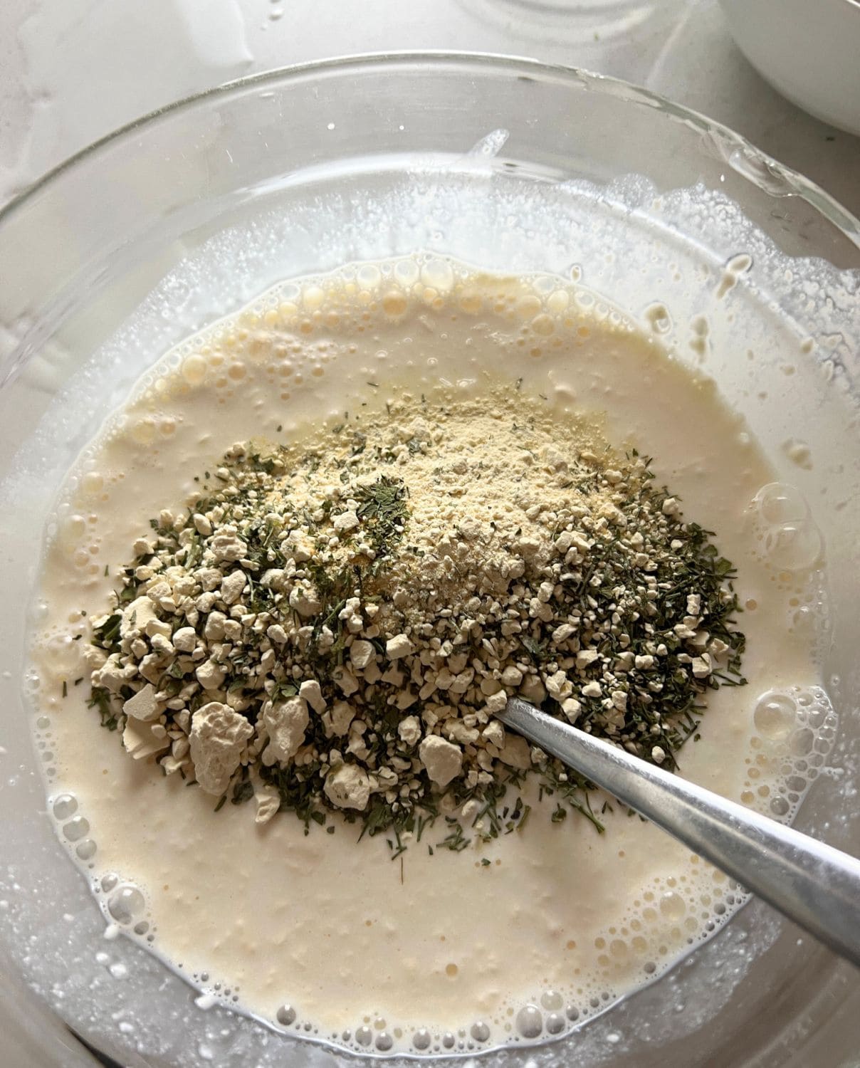 Dry ingredients mixed with wet ingredients for ranch dressing. 