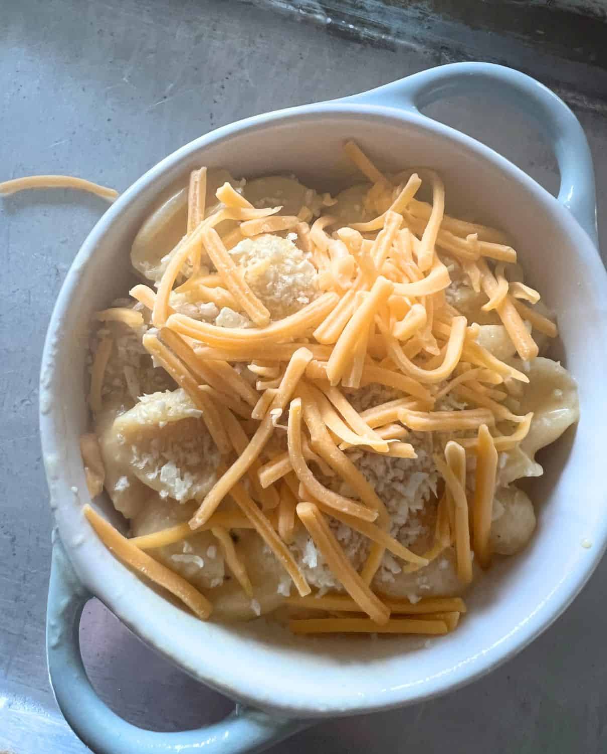 Mac and cheese in a ramekin ready for broiler.