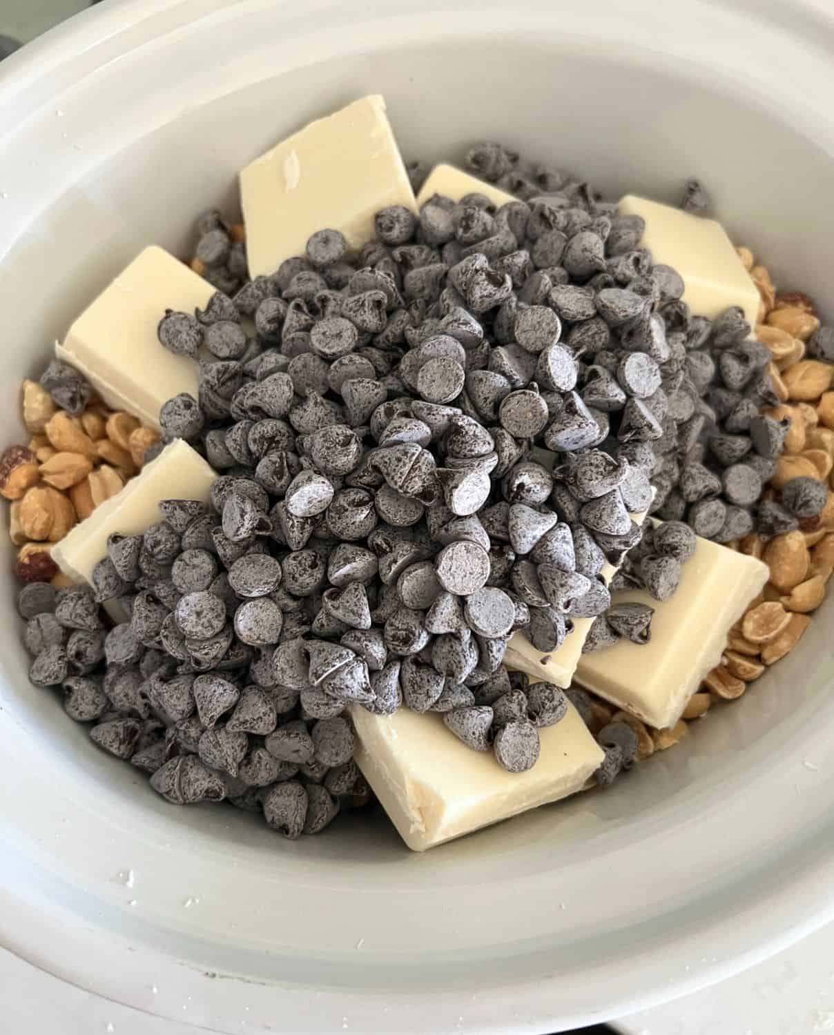 Peanuts and chocolate in a slow cooker. 