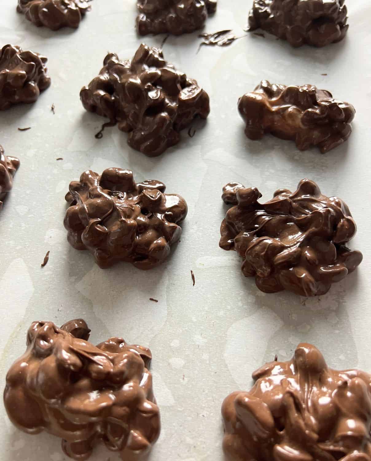 Chocolate peanut clusters on a sheet pan. 