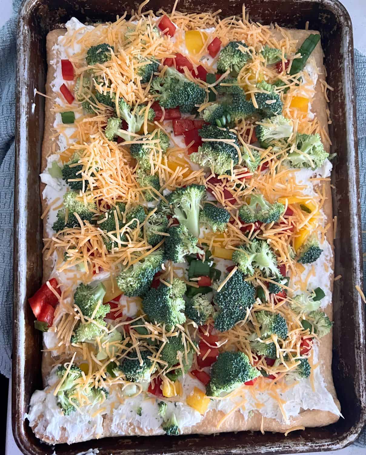 Veggie ranch pizza topped with vegetables and cheese. 