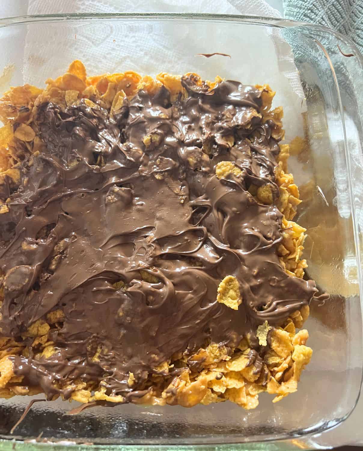 Melted chocolate chips poured over cornflake bars. 