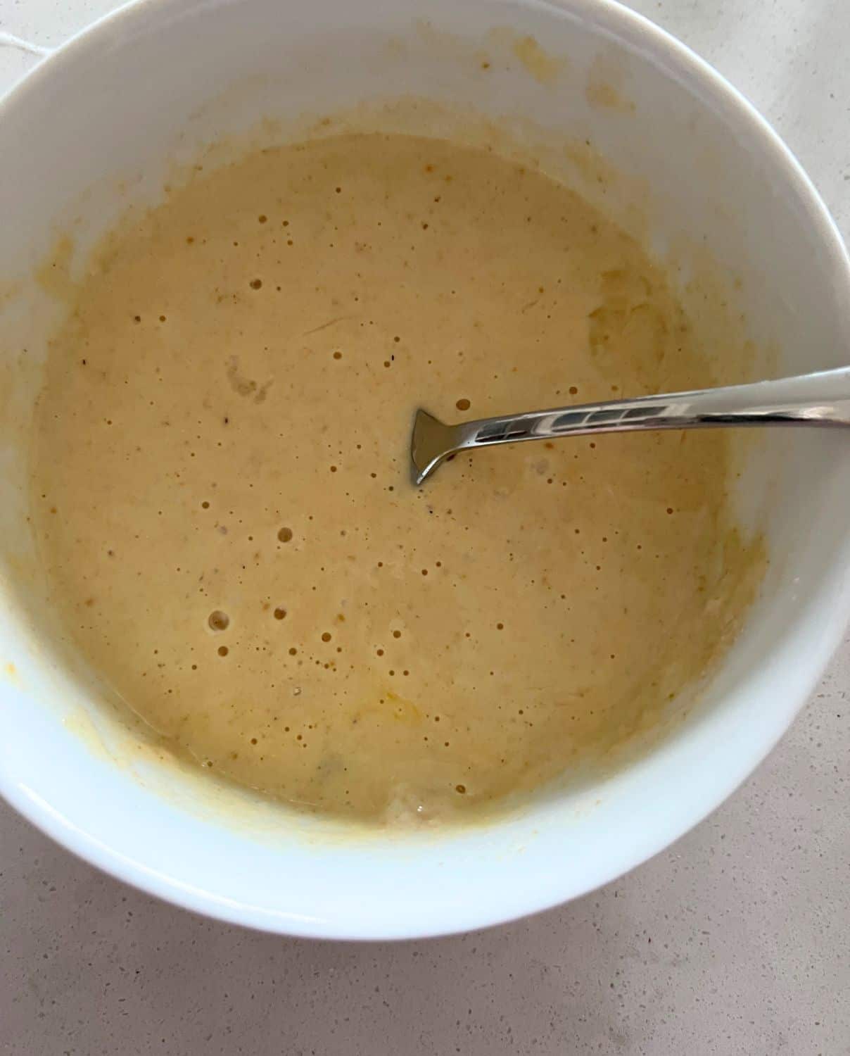 Waffle ingredients mixed together in a bowl. 