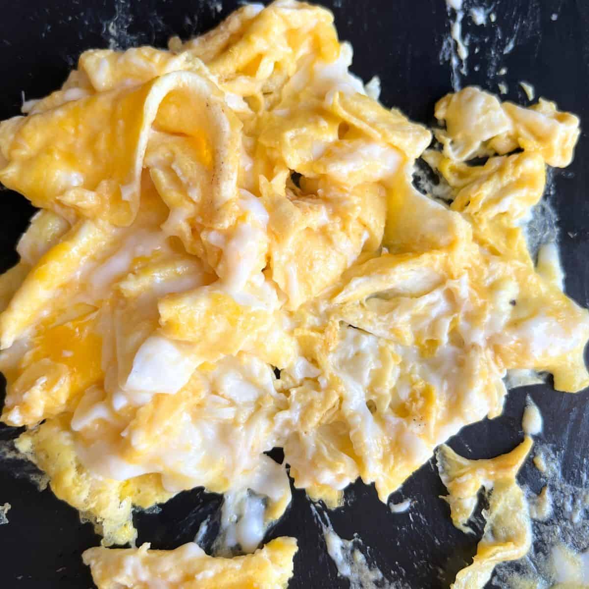 Finished cooked scrambled eggs on a Blackstone griddle. 