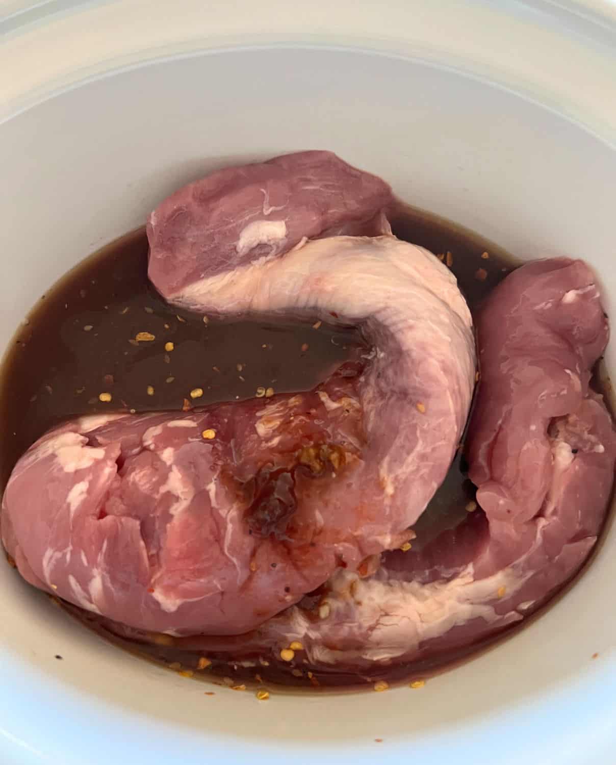 Pork tenderloins with sauce in a crock pot. 