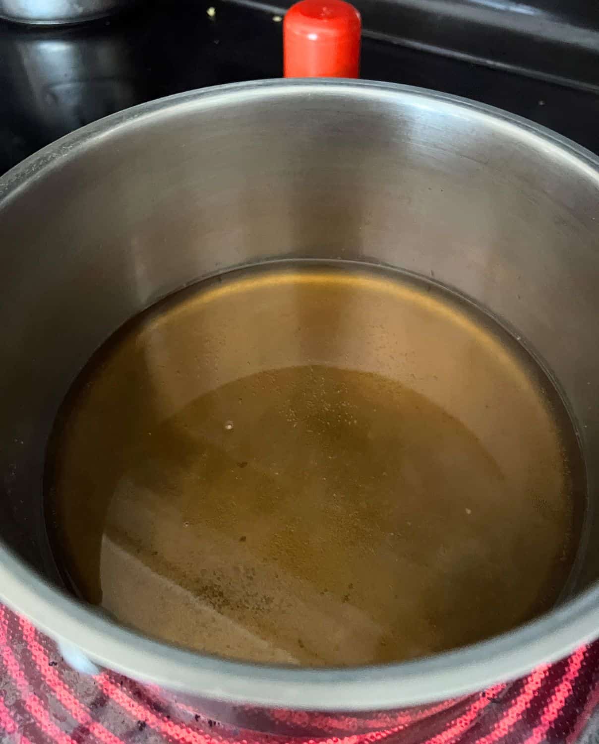 Sugars and water combined in a pan. 