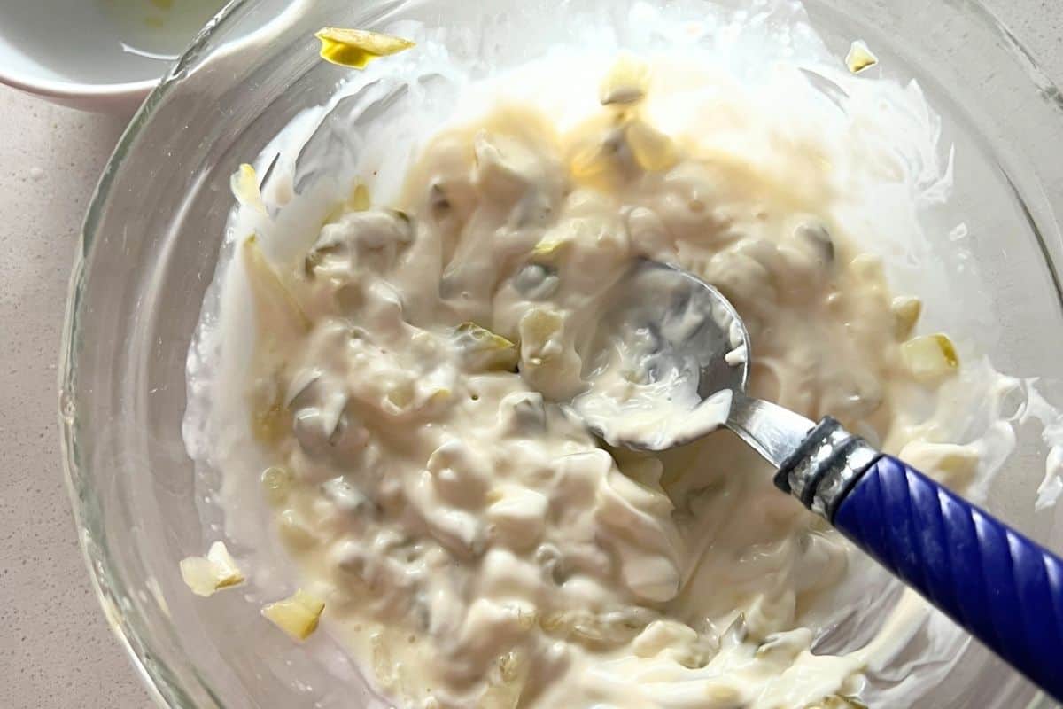 Ingredients for tartar sauce combined in a bowl. 