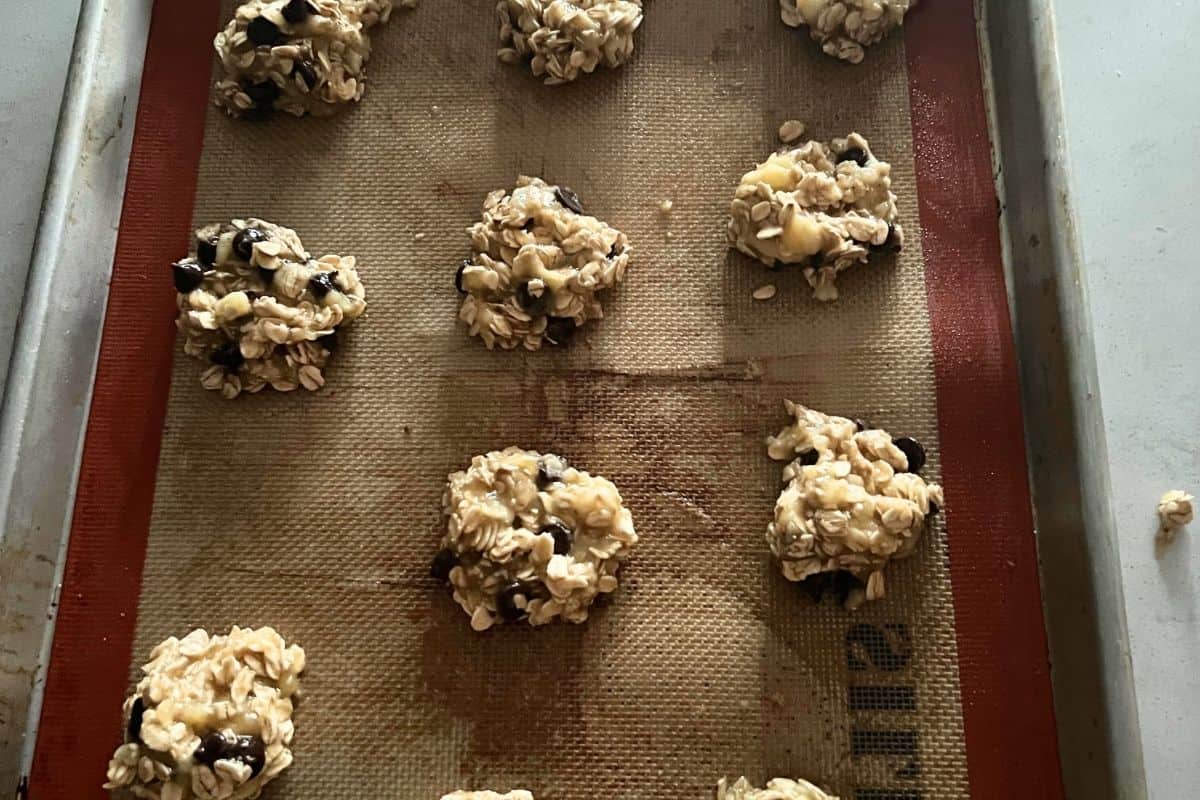 Banana Oat Cookies scooped on a sheet pan. 
