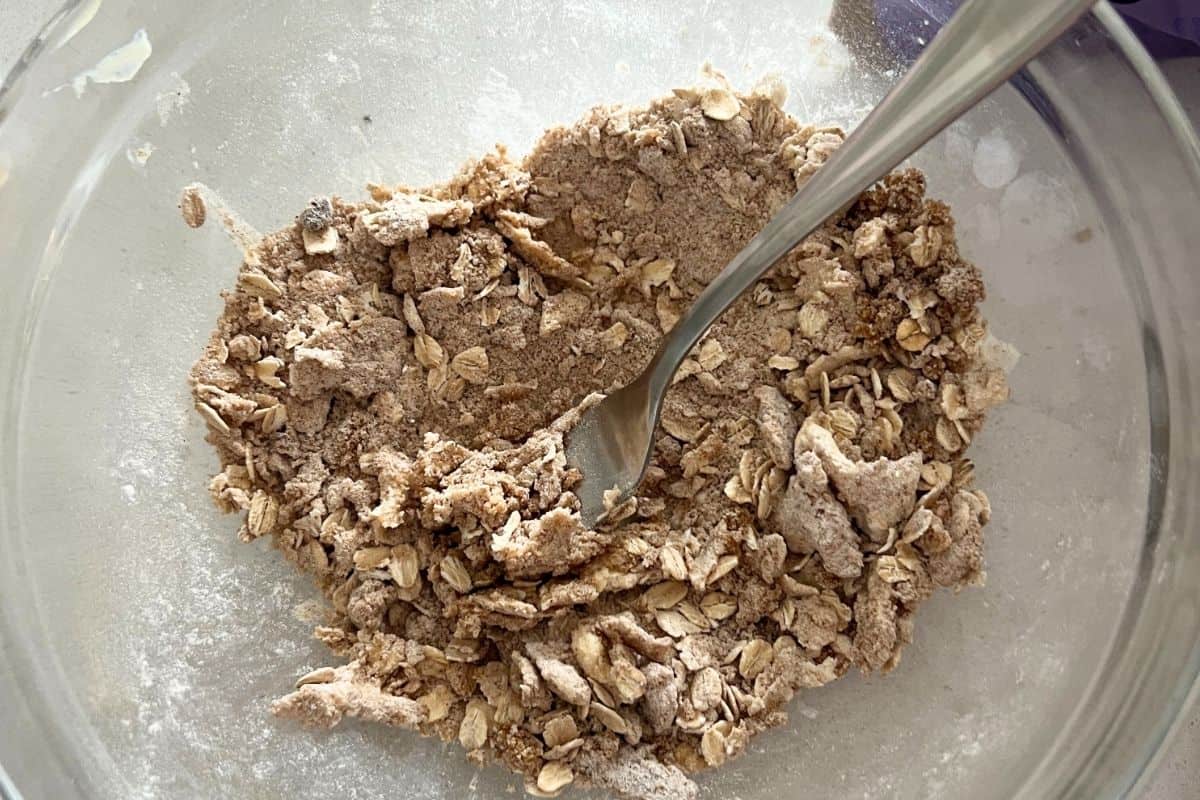 Mixed butter, oats, flour, cinnamon, and sugar together in a bowl. 