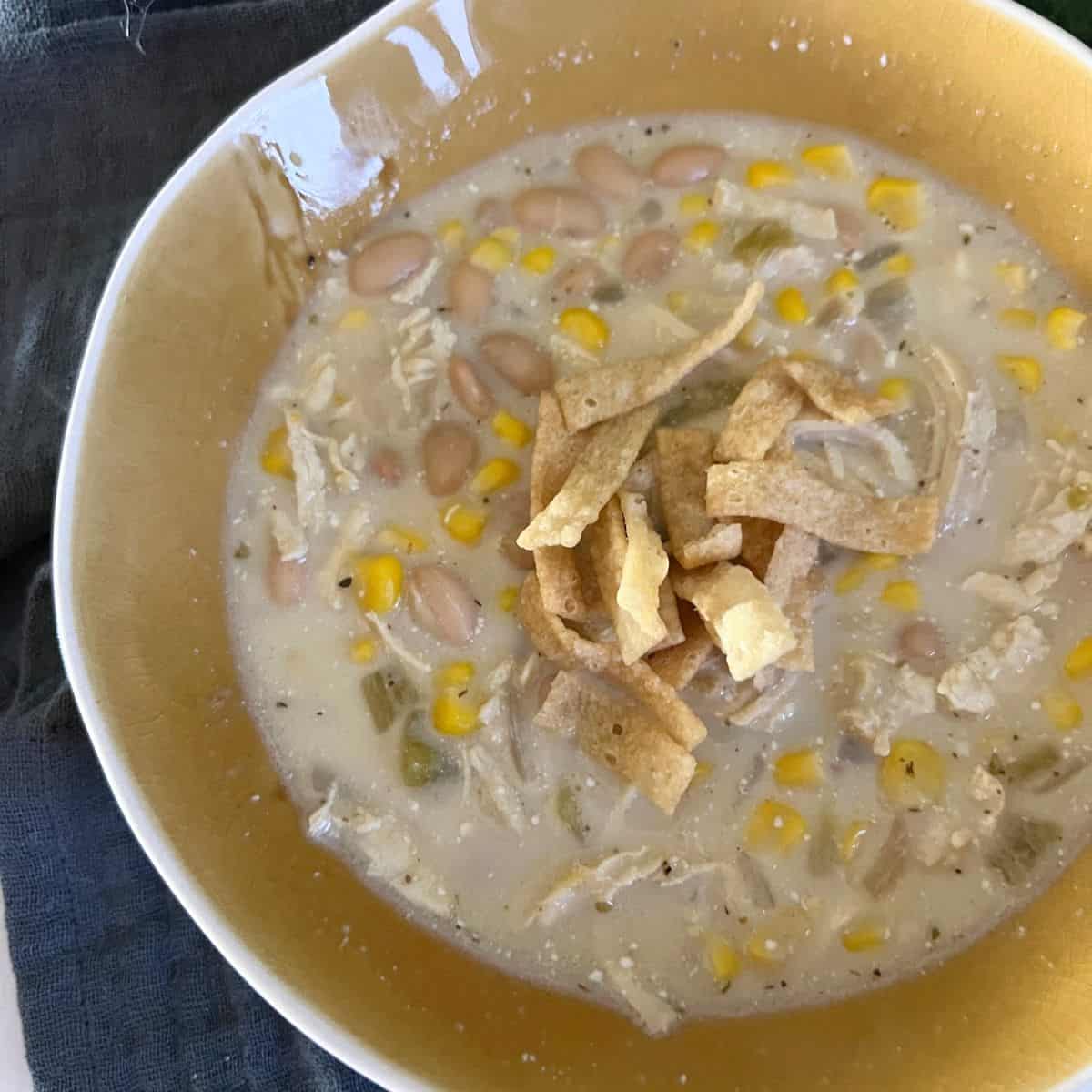 Creamy White chicken chili is loaded with Great Northern Beans, Chicken, corn, chilis, and chicken broth. You can add in your typical spices that you would add in regular beef chili to give it some flavor. 