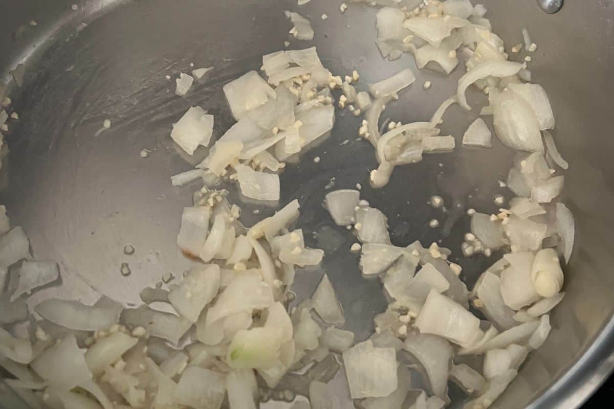 Onions and garlic cooking in a skillet. 