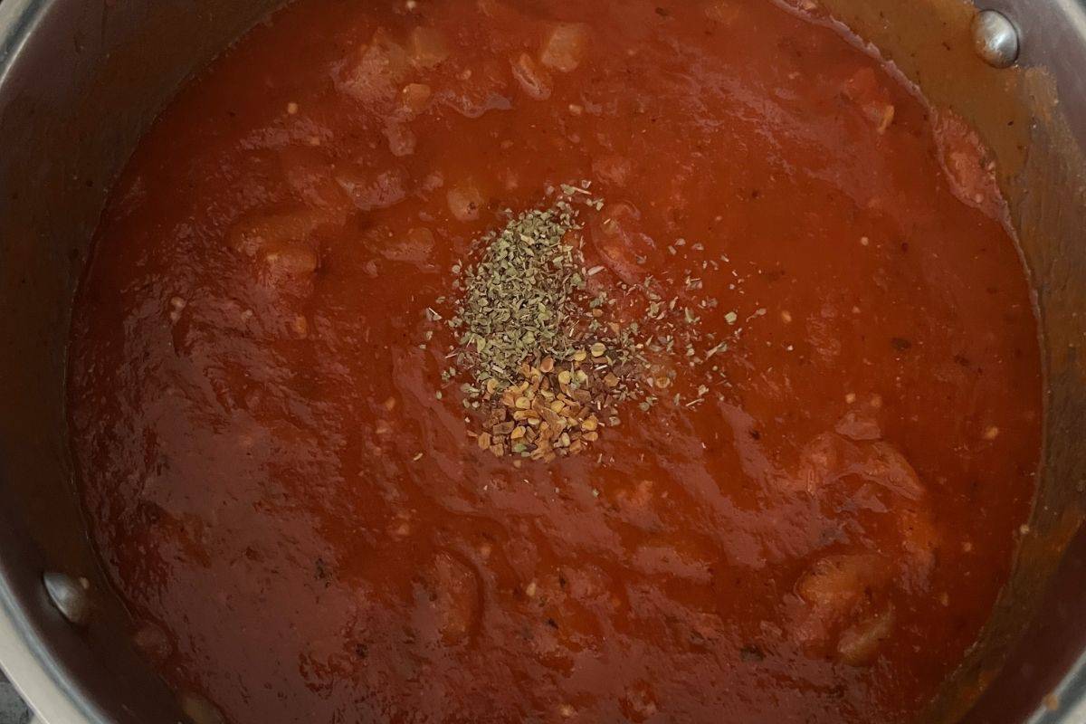 Seasoned marinara sauce in a skillet. 