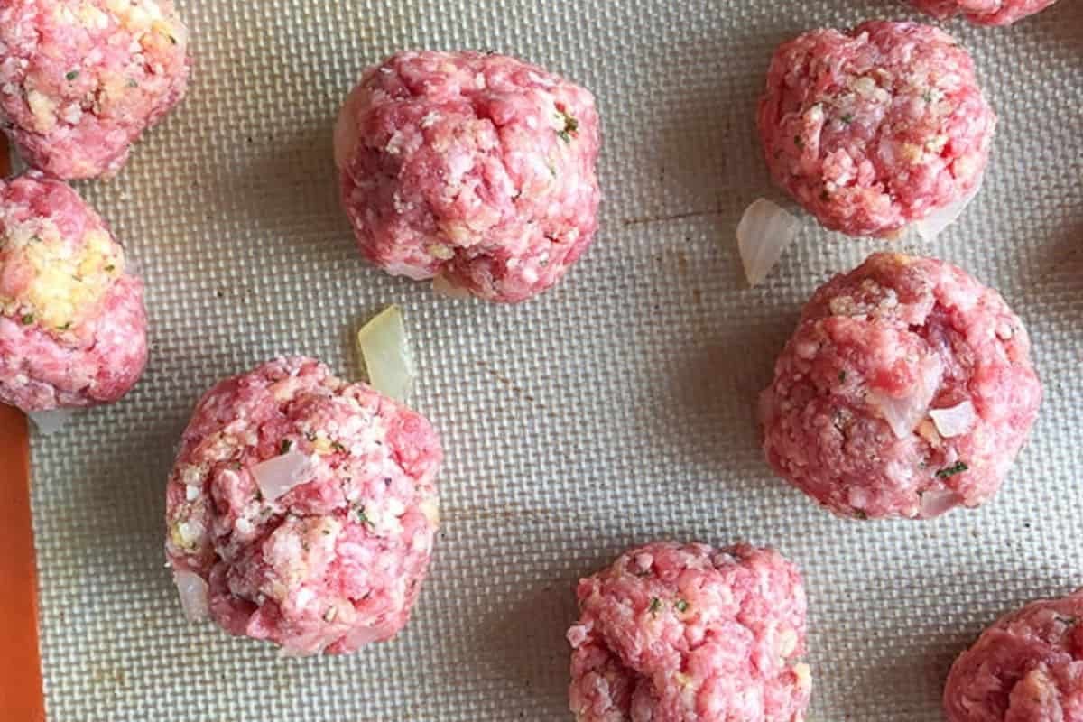 Shaped meatballs on a baking sheet. 