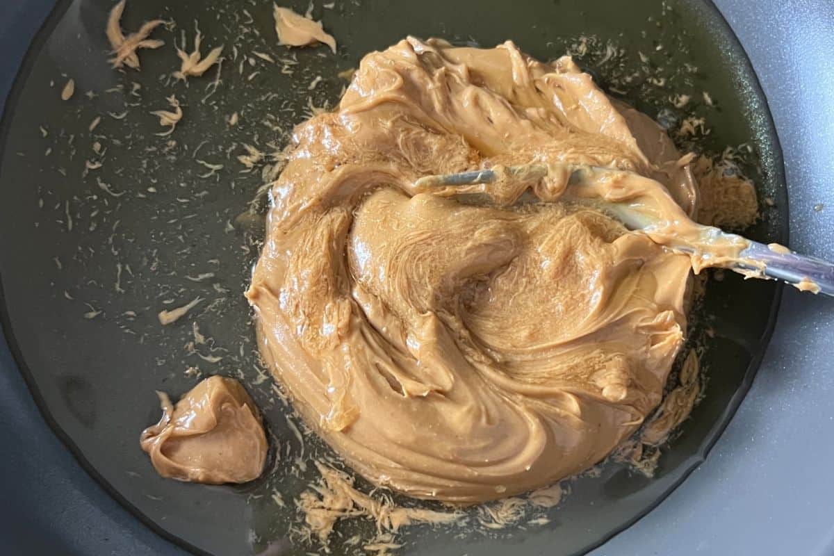 Peanut butter and honey melting in a sauce pan on the stove. 